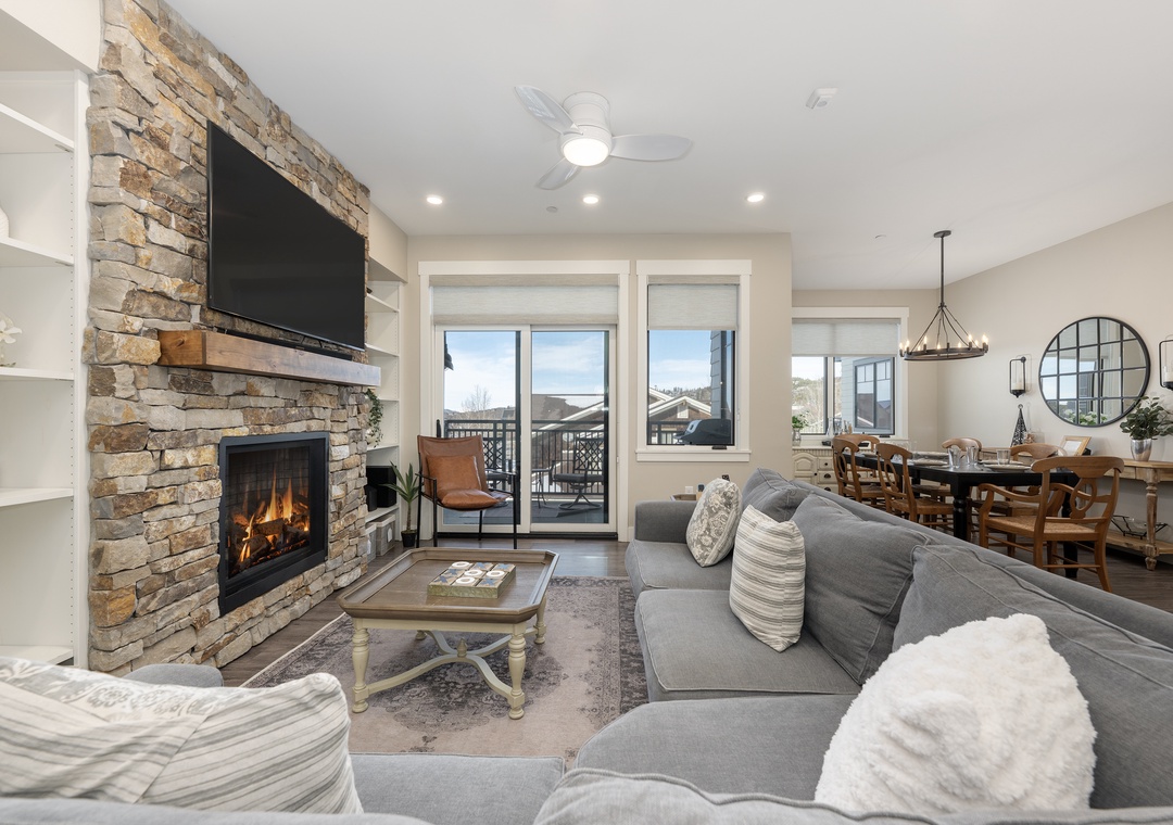 Unwind in your spacious living room where the stone fireplace creates a cozy ambiance and your private balcony offers peaceful views.