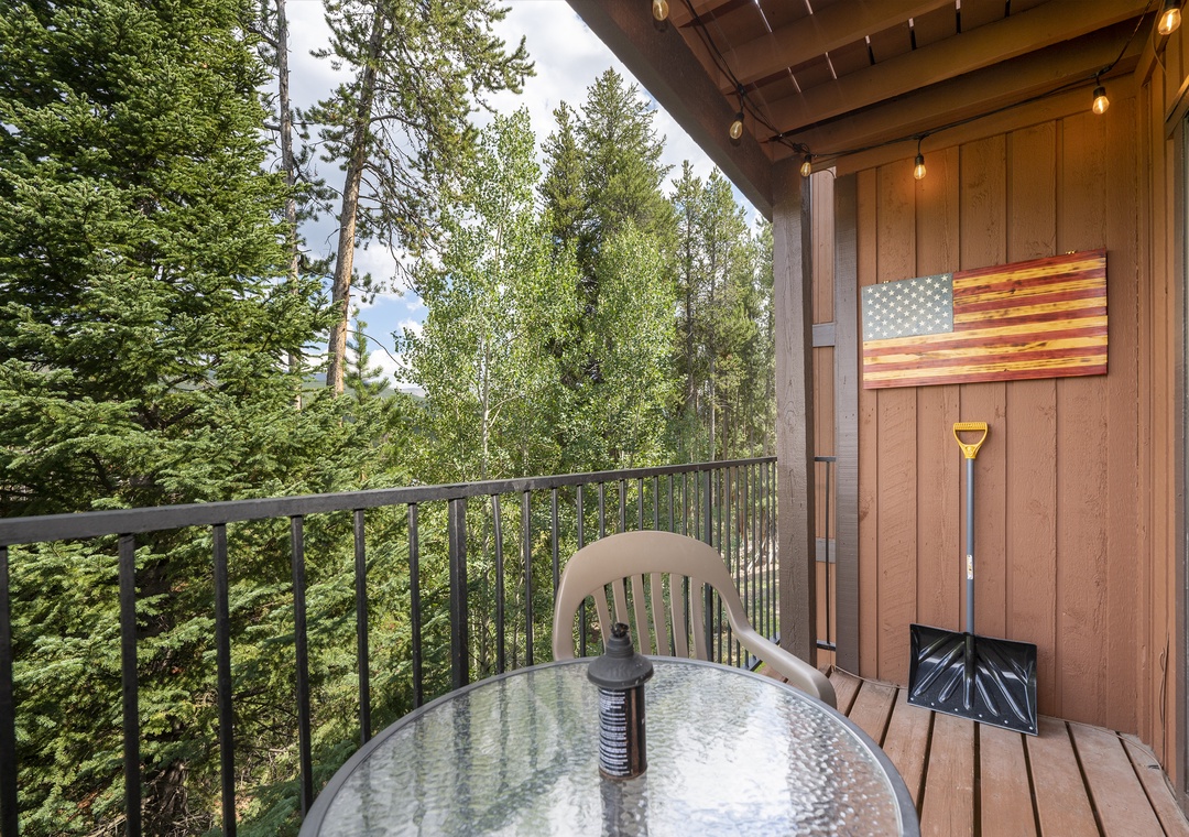 Step onto your private balcony where forest views stretch endlessly before you, complete with outdoor dining and charming string lights for magical evenings.