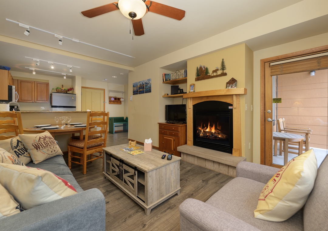 Cozy up by your crackling fireplace with mountain views from this warm living space designed for perfect relaxation.