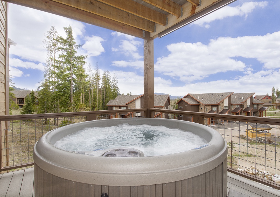 Soak in your private hot tub while taking in stunning mountain views from this covered balcony retreat.