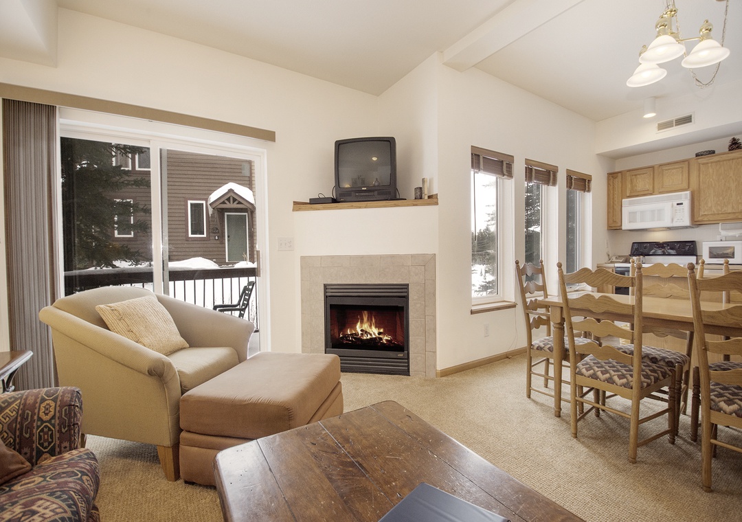Cozy up by your private fireplace while snowflakes dance outside. This warm living space blends comfort with mountain charm perfectly.