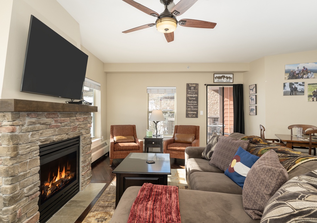 Cozy up by your crackling fireplace at base Camp 305 while you watch TV in this warm living space with comfortable seating and mountain charm.