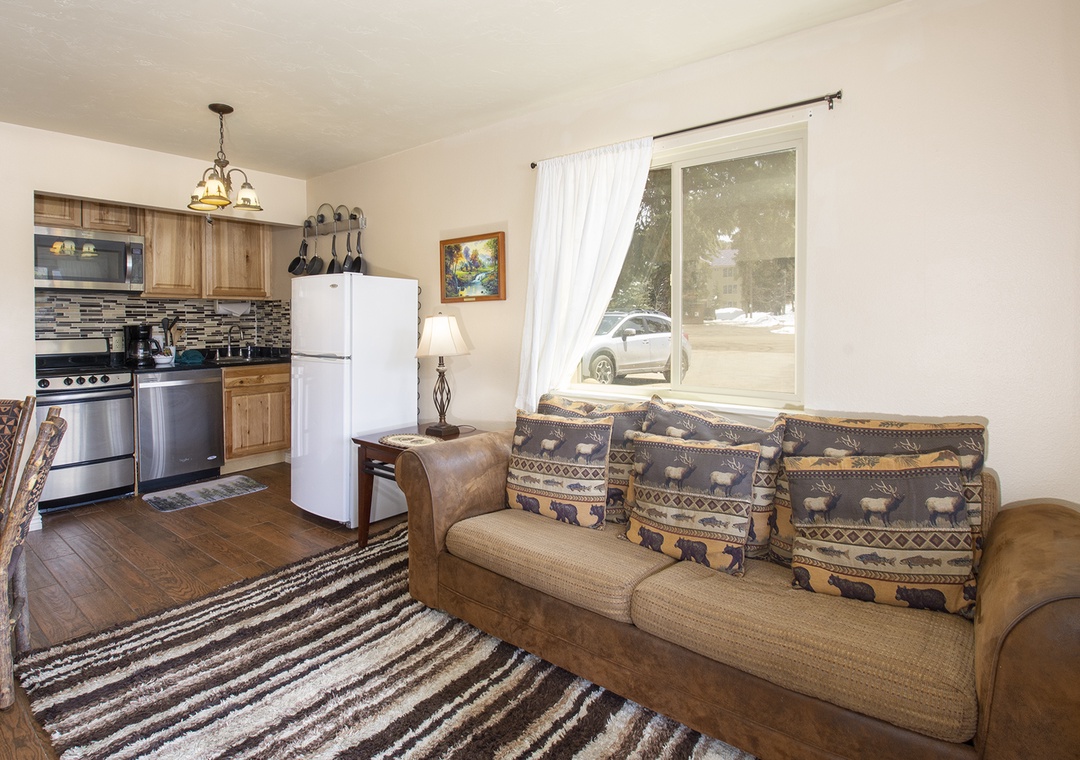 Sink into your comfortable sofa and enjoy this cozy open-concept living space where rustic charm meets modern convenience in your home-away-from-home.