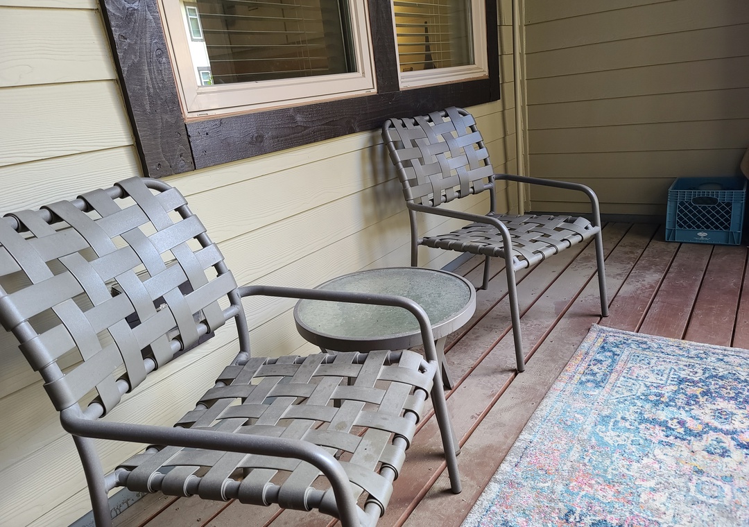 Step onto your private covered patio and settle into stylish woven chairs where you can unwind with morning coffee or evening conversations.