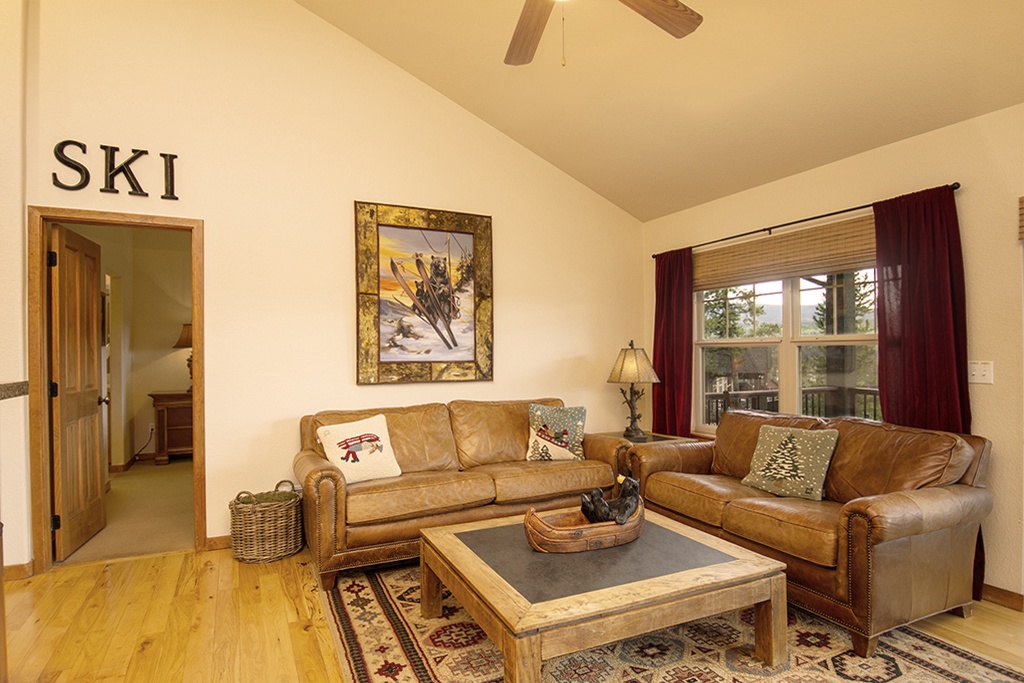 Sink into cozy leather sofas in your mountain retreat, where rustic charm meets comfort beneath vaulted ceilings.