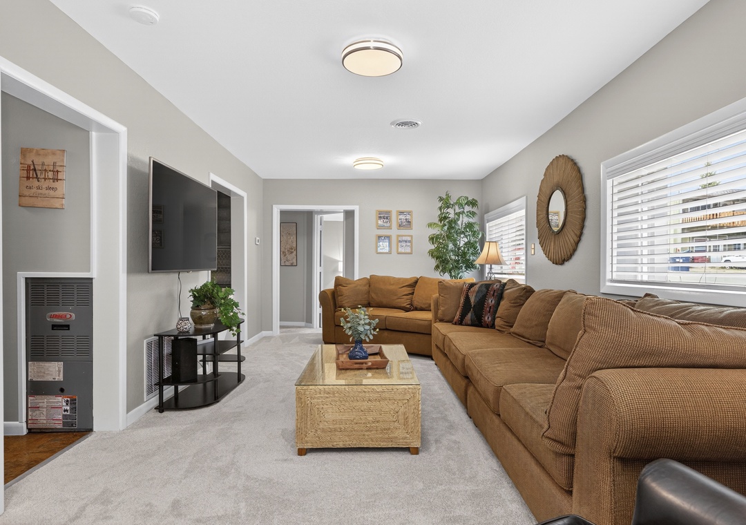 Sink into the plush sectional and unwind in your spacious, light-filled living room, perfect for movie nights or simply relaxing after a day of adventure.