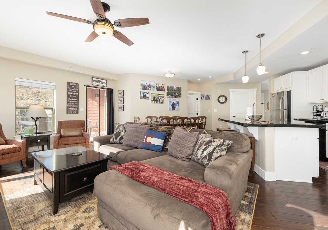 Settle into Base Camp 305 your spacious open-concept living room, where cozy seating flows into a fully equipped kitchen perfect for gathering.