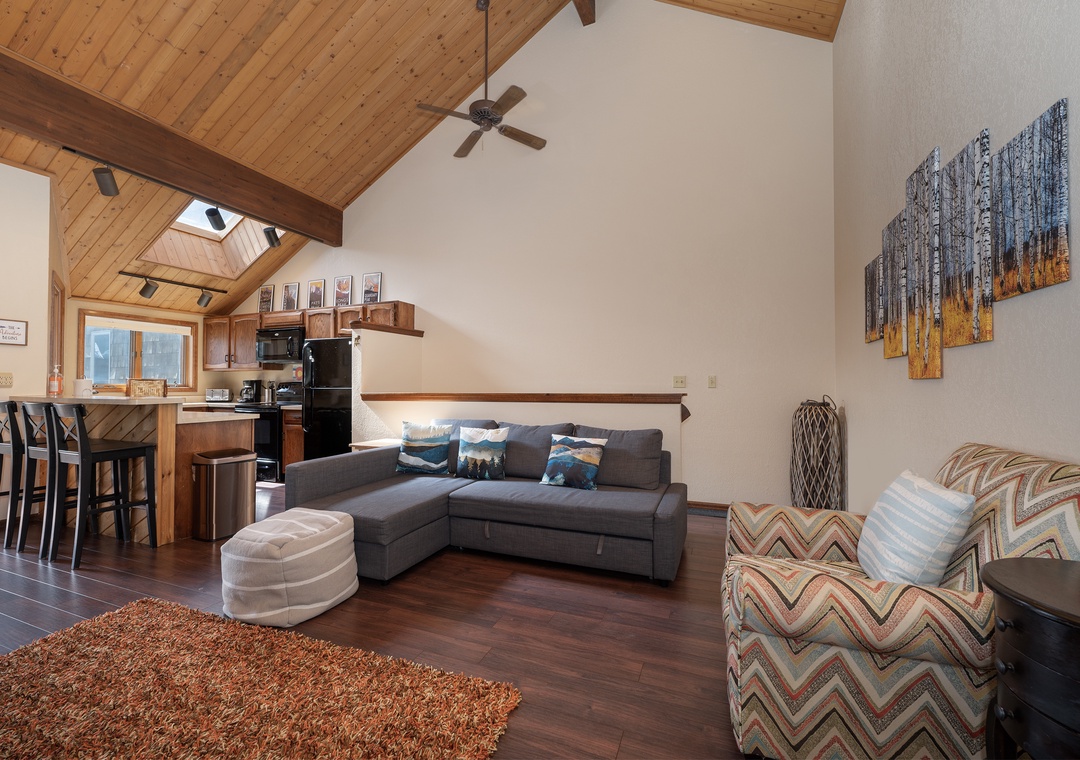 Relax in your spacious mountain retreat with soaring ceilings, cozy seating, and a full kitchen perfect for preparing meals together.