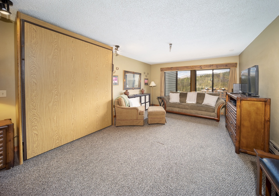Your spacious living room features comfortable seating and a large TV, perfect for relaxing after mountain adventures.