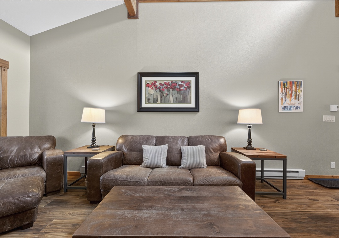 Sink into plush leather sofas with soft pillows, surrounded by warm wood accents and glowing lamps—your perfect spot to unwind after a day of adventure.