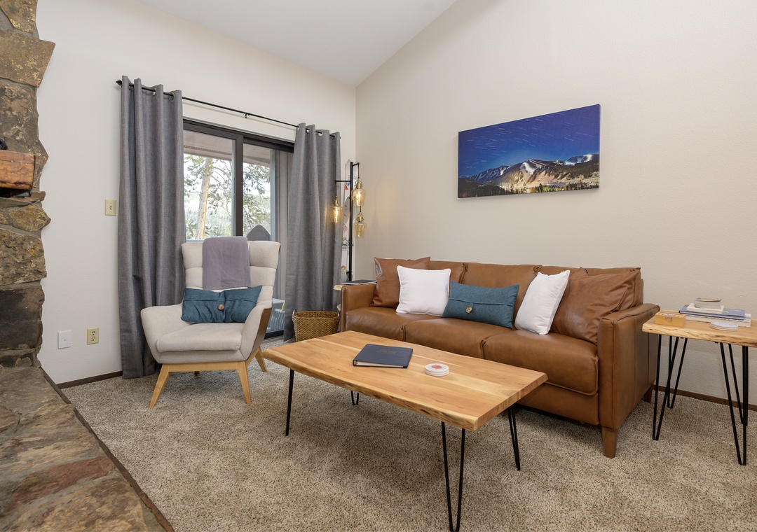 Sink into the plush leather sofa and unwind in your stylish mountain retreat, where rustic charm meets modern comfort.