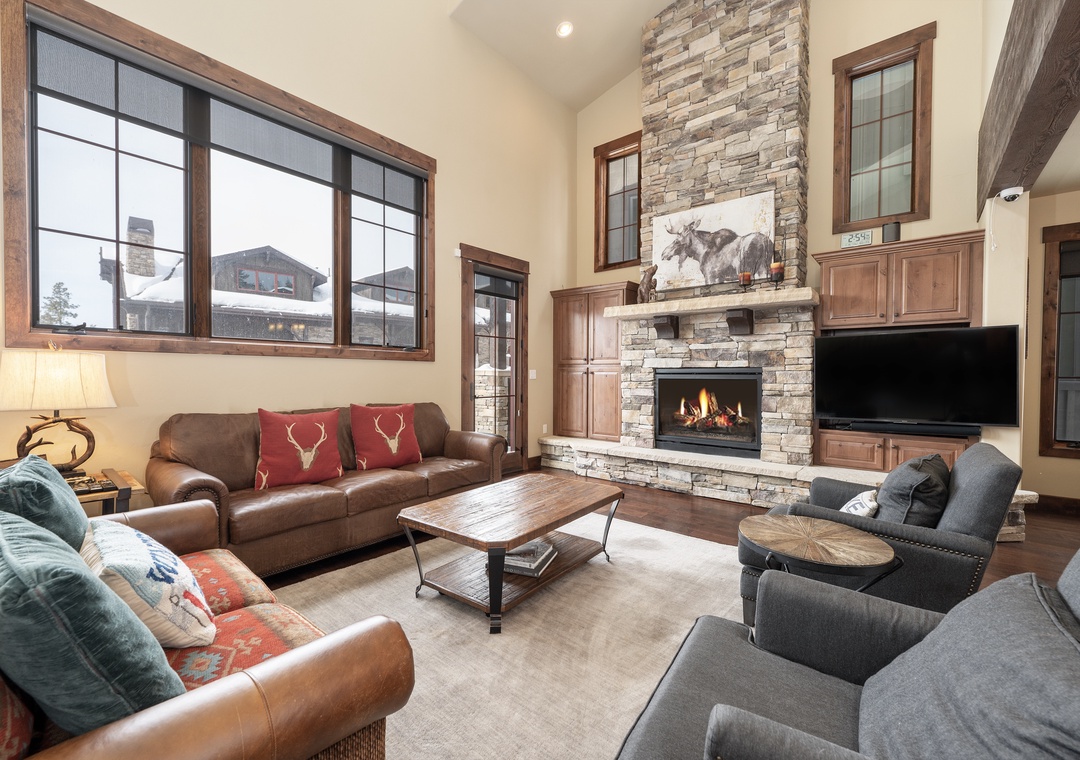 Cozy up by the crackling stone fireplace as you sink into plush leather sofas, enjoying mountain views through expansive windows.