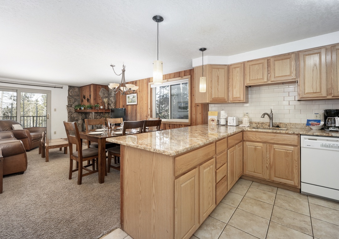 Gather in your spacious kitchen with granite counters and island, flowing seamlessly into the cozy living and dining areas for memorable meals together.