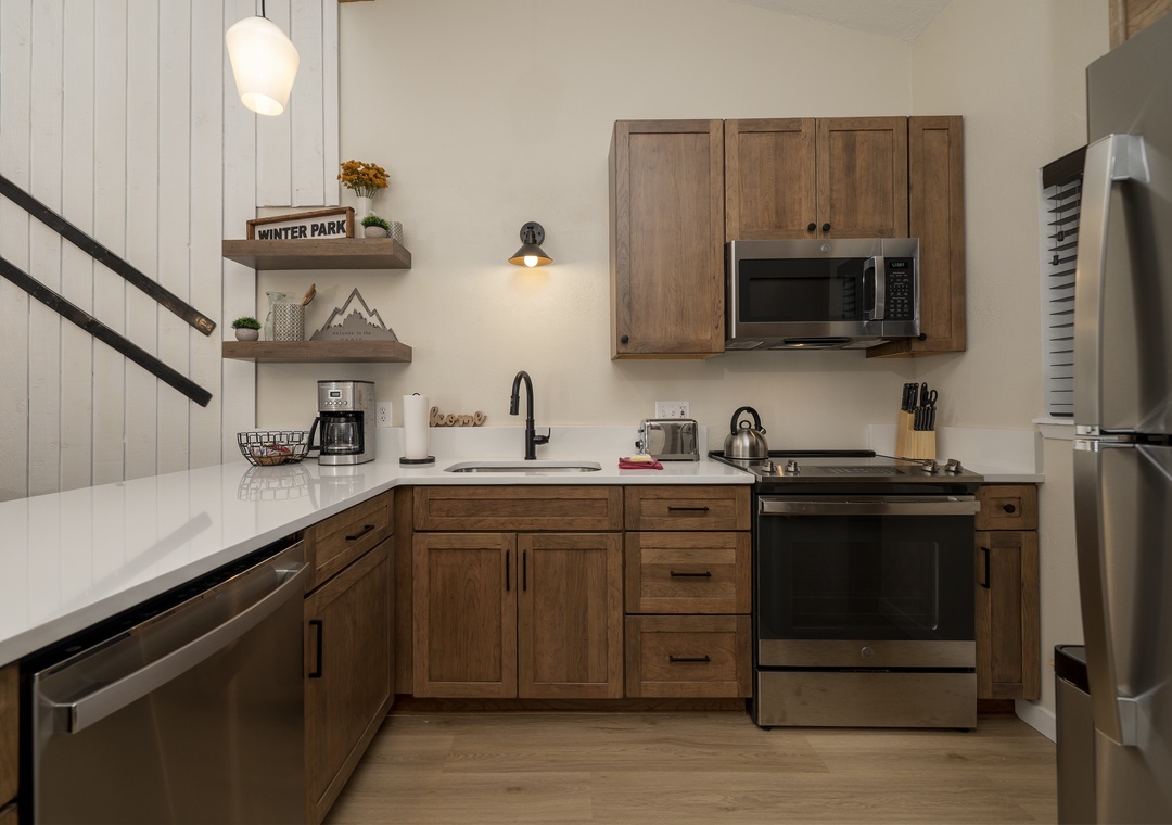Your fully equipped kitchen features warm wood cabinetry, stainless steel appliances, and everything you need to create memorable meals.