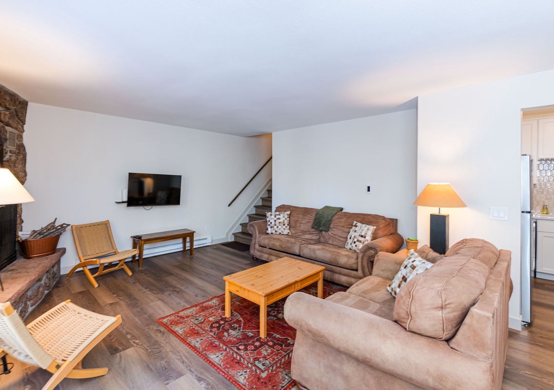 Settle into your cozy living room with plush leather sofas, warm fireplace, and flat-screen TV for perfect evenings in.