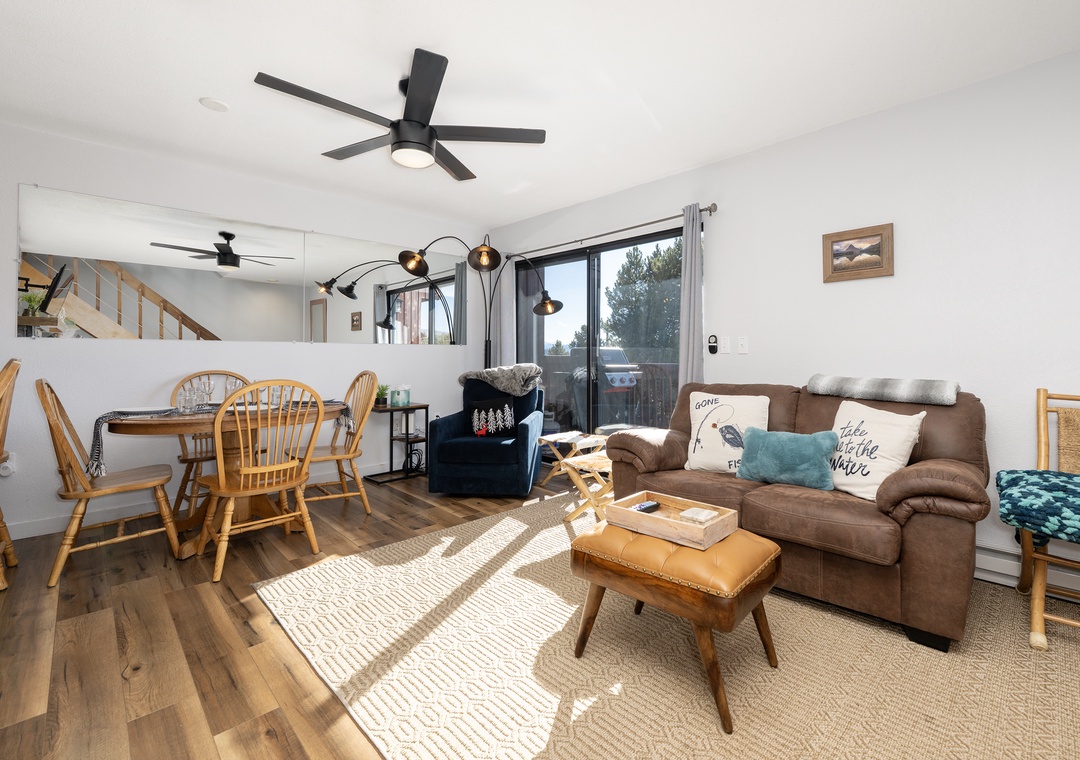 Relax in your bright, open living space at Soda Springs Ranch condo 3C with cozy seating, warm wood accents, and natural light streaming through large windows.