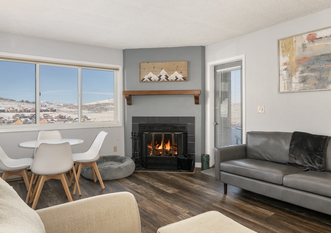 Cozy up by your crackling fireplace at Summit Unit 1103 while taking in breathtaking mountain views through expansive windows in this stylish living space.
