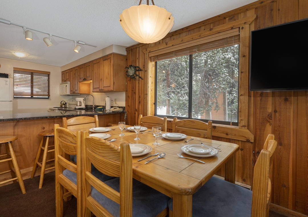 Gather around your cozy dining table for memorable meals in this warm wood-paneled space with mountain views.