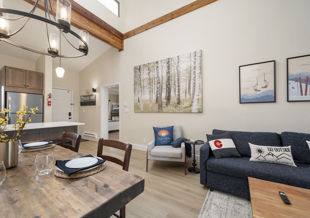 Your open-concept living space blends rustic wood beams with modern comfort, creating the perfect spot to unwind after mountain adventures.