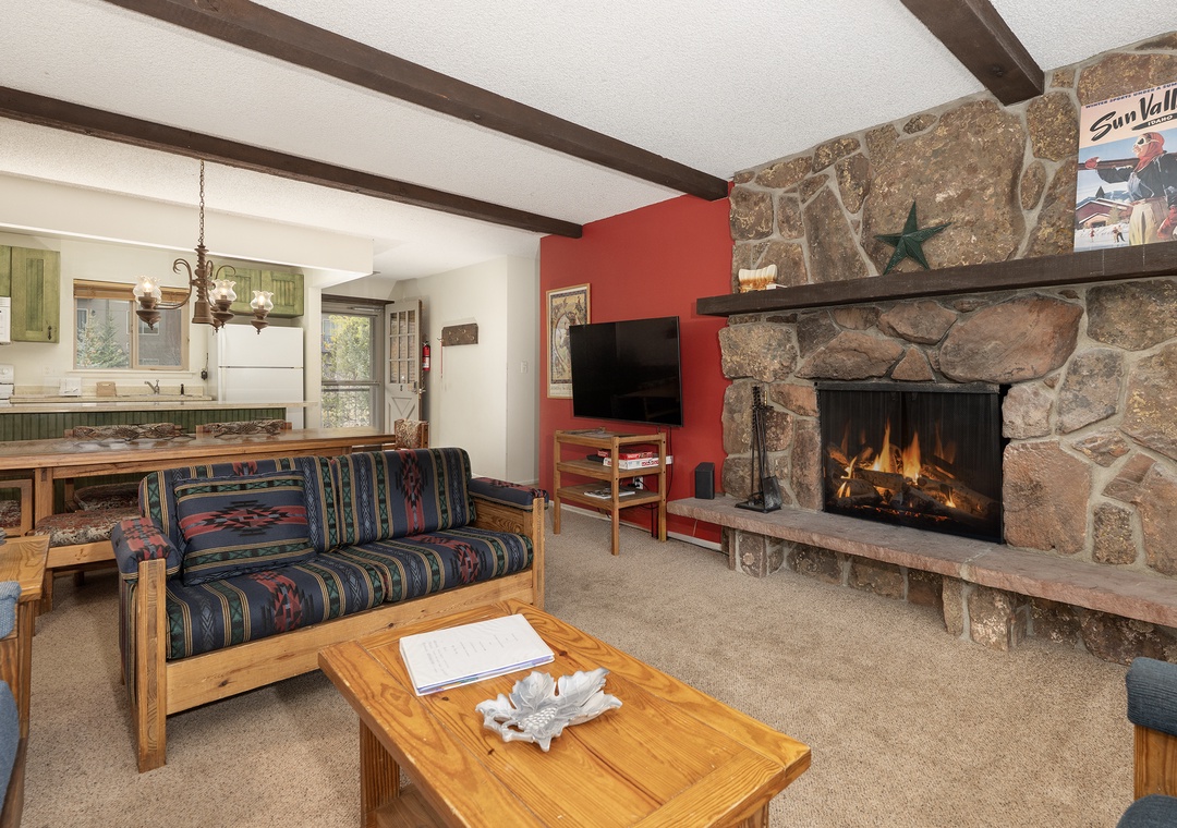 Cozy up by your stone fireplace in this welcoming living space with rustic charm and modern comfort.