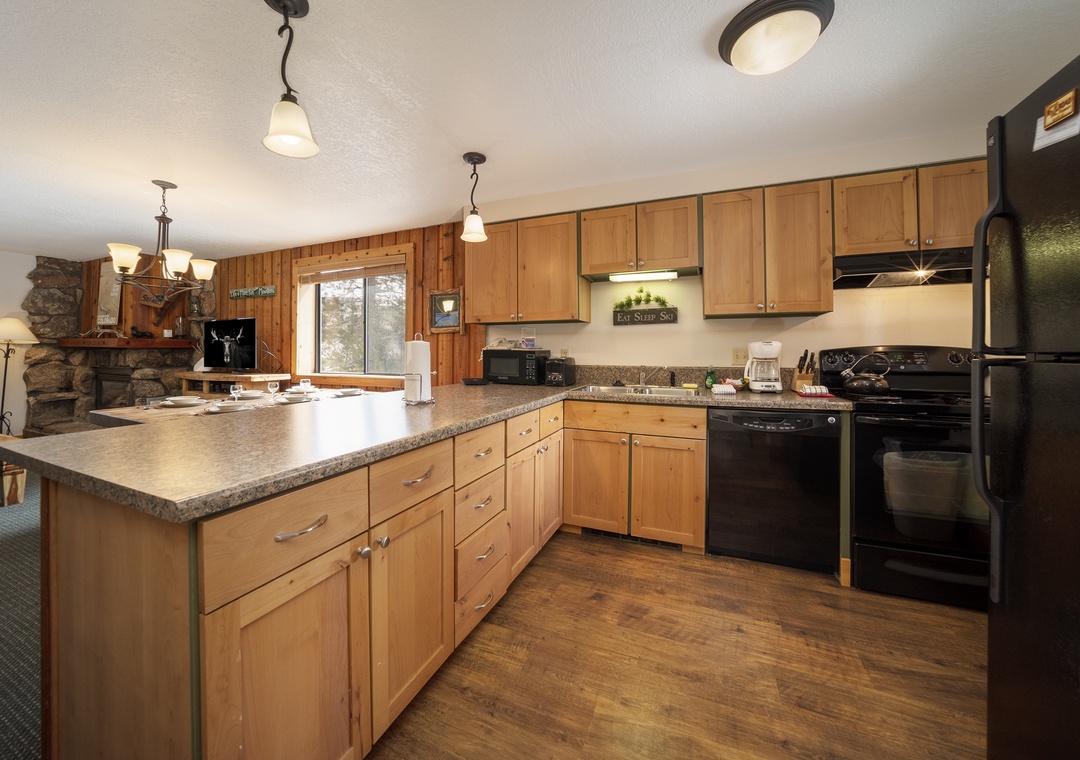 Your fully equipped kitchen features warm wood cabinets, granite counters, and all the essentials for preparing memorable meals together.