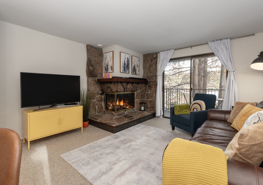 Cozy up by your crackling stone fireplace while enjoying mountain views from this inviting living space with modern amenities.