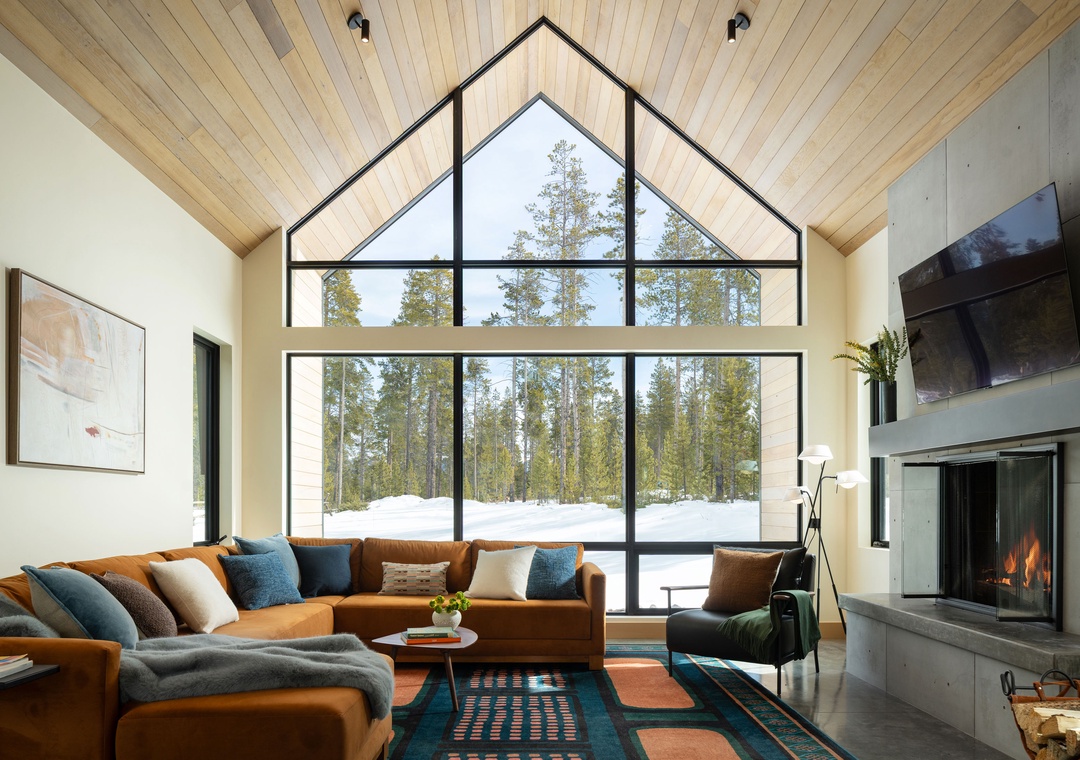 Sink into plush seating and let your eyes wander to the forest beyond your floor-to-ceiling windows. The soaring wood ceilings and crackling fireplace create your perfect mountain retreat.