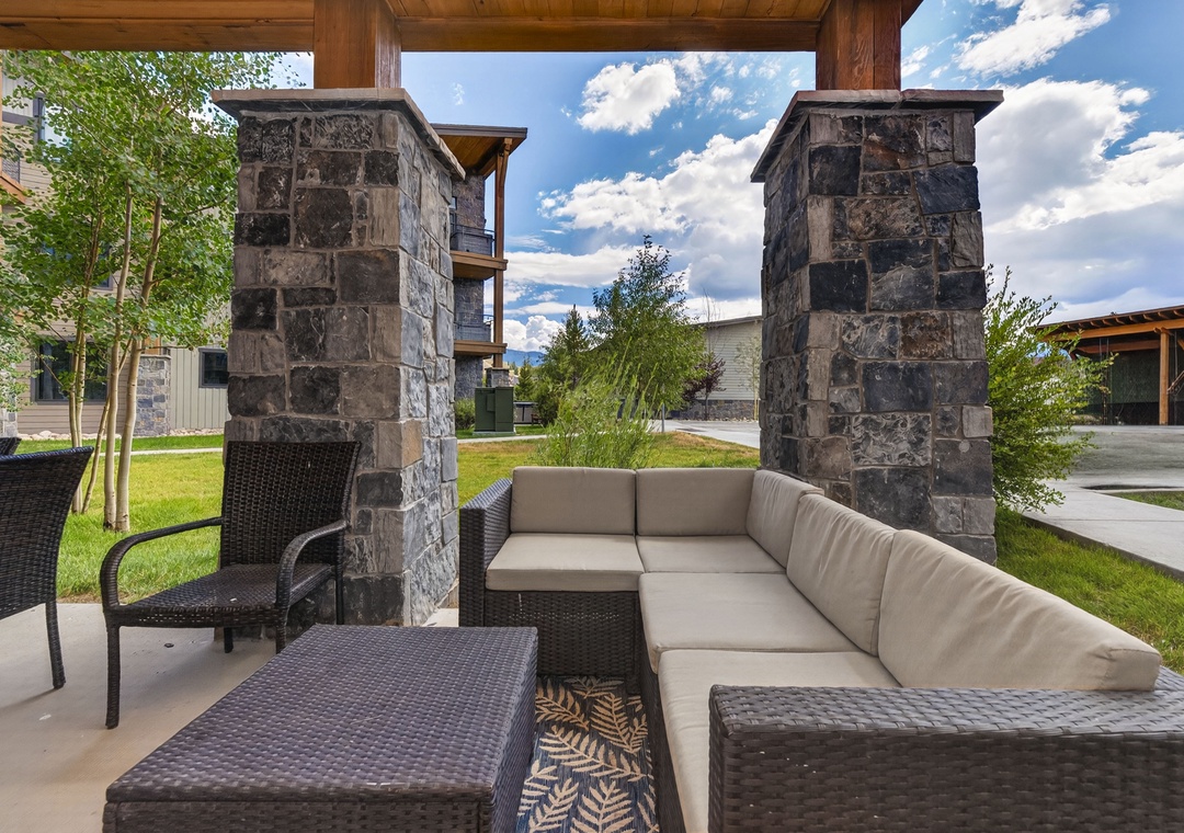 Unwind in your own covered patio retreat, where plush outdoor seating invites you to relax beneath the open sky and take in the peaceful mountain air.