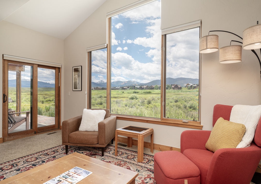 Unwind in your bright living space with sweeping mountain views through floor-to-ceiling windows, perfect for morning coffee moments.