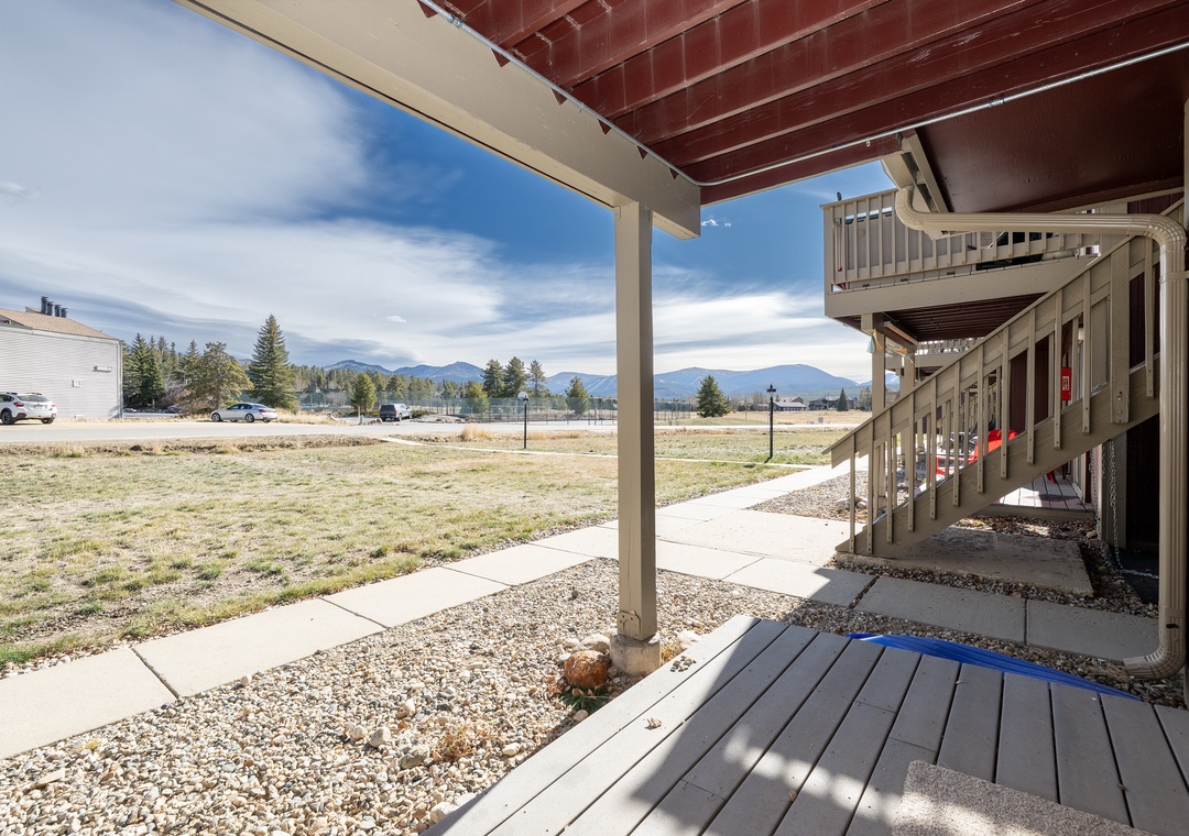 Your private covered patio offers peaceful mountain views and direct walkway access, perfect for morning coffee or evening relaxation.
