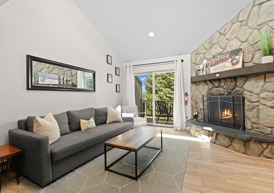 Relax on the plush sofa by your stone fireplace, then step outside to your private balcony surrounded by lush greenery and mountain air.