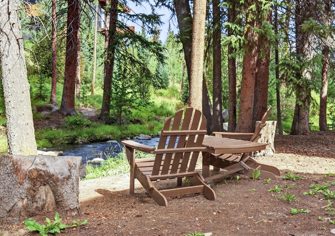 Relax in your private creekside seating area surrounded by towering pines, where the gentle sounds of flowing water and birdsong create your perfect mountain escape.
