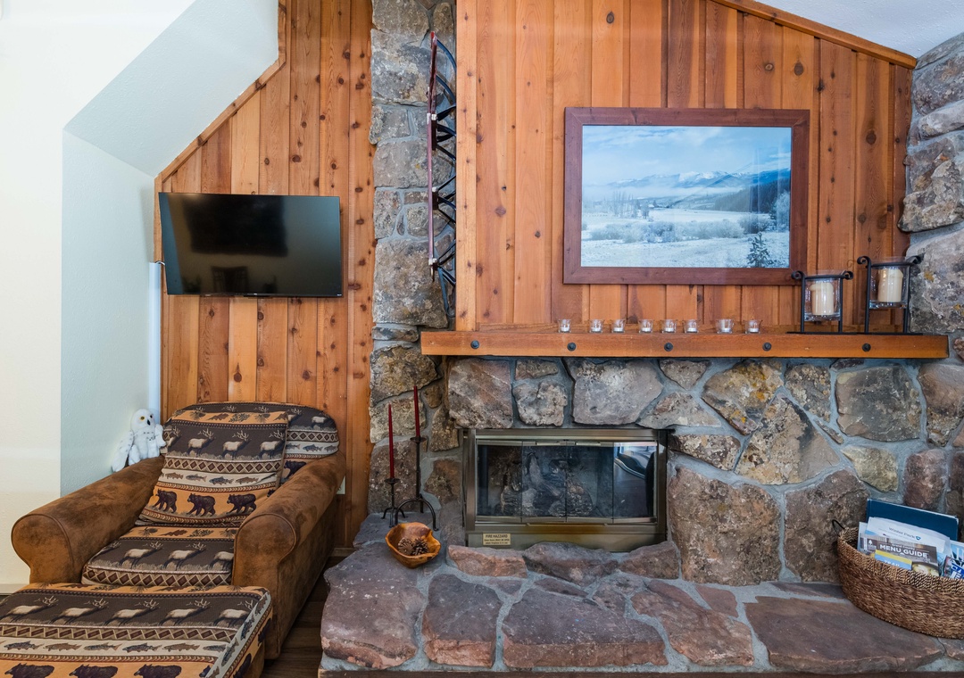 Cozy up by your rustic stone fireplace with mountain views, perfect for unwinding after alpine adventures.