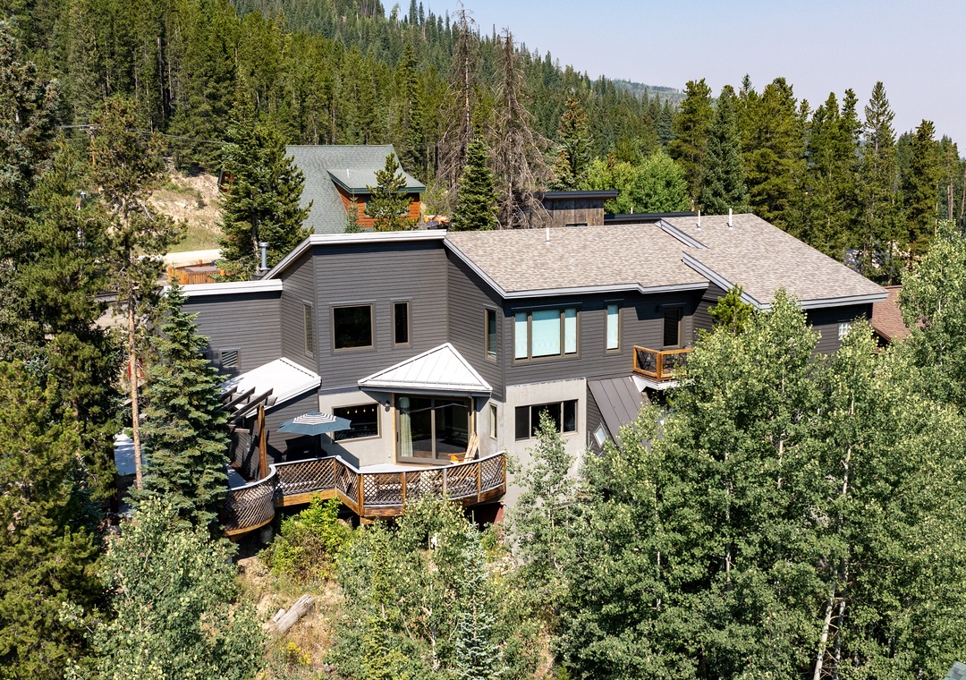 Stunning mountain property nestled among towering evergreens with expansive forest views and natural privacy.