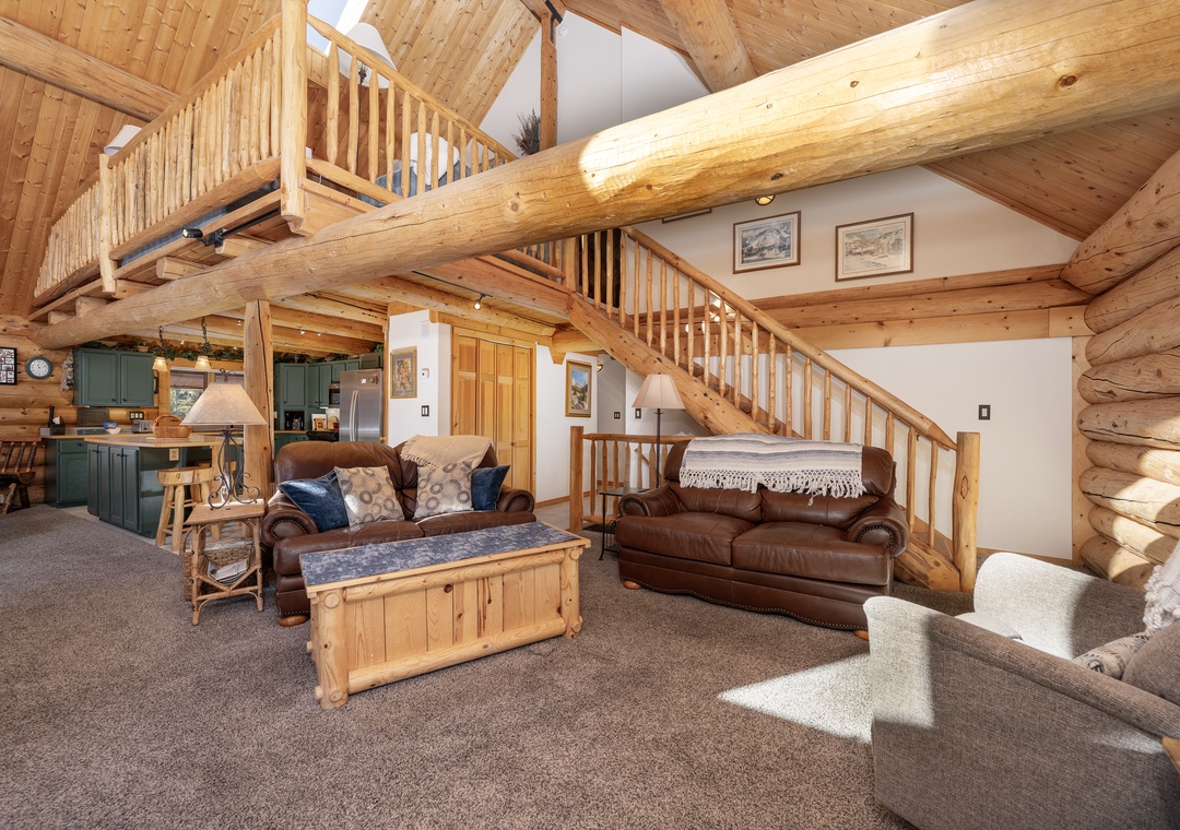 Sink into plush leather sofas surrounded by warm log beams and rustic charm in this inviting living space.
