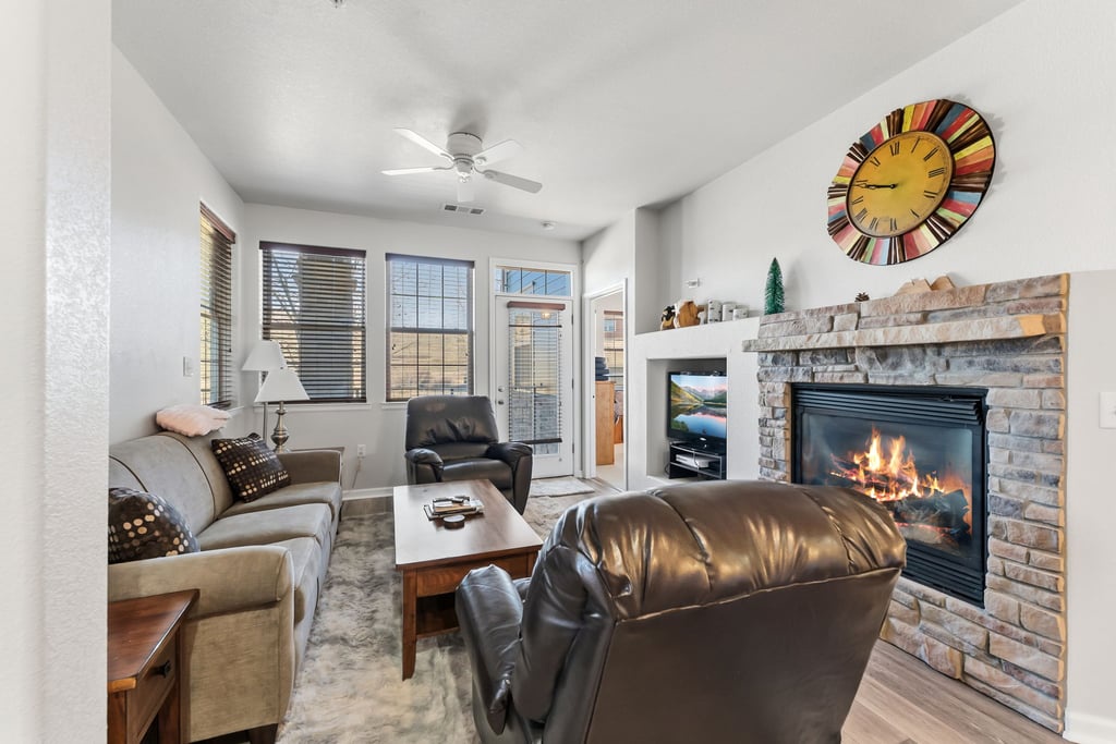 Unwind in your cozy living room where crackling fireplace flames create the perfect ambiance for relaxing evenings with loved ones.