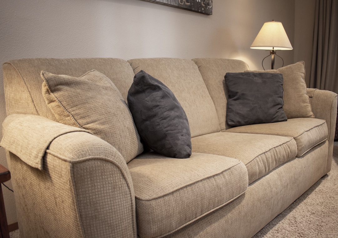 Sink into this plush sofa with soft throw pillows and warm lamp lighting for your perfect evening unwind.