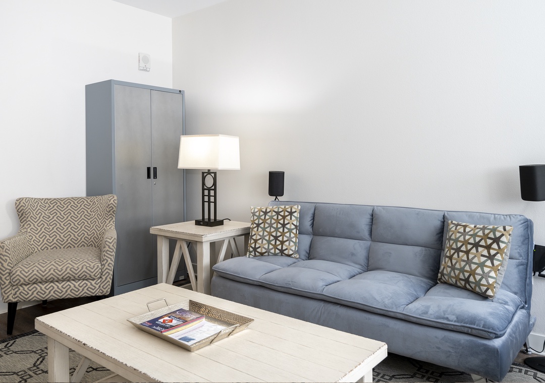 Sink into soft blue cushions and unwind in your stylish living space, perfectly appointed with cozy seating and thoughtful touches.