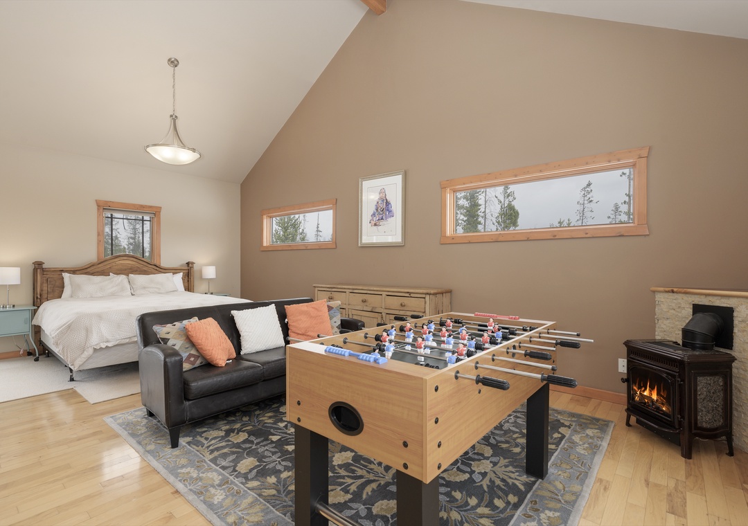 Your spacious retreat combines comfort with play—unwind by the fireplace or challenge friends to foosball in this cozy bedroom suite.