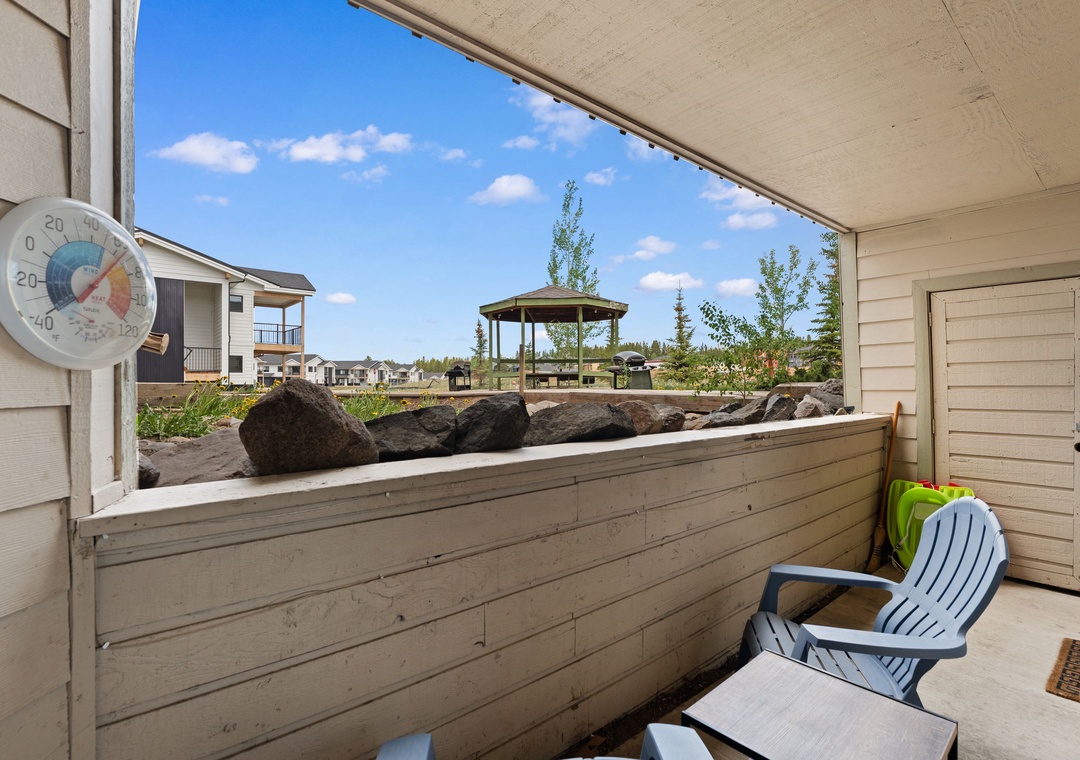 A covered patio offers neighborhood views with a gazebo, natural rock features, and outdoor seating for relaxing on sunny days.