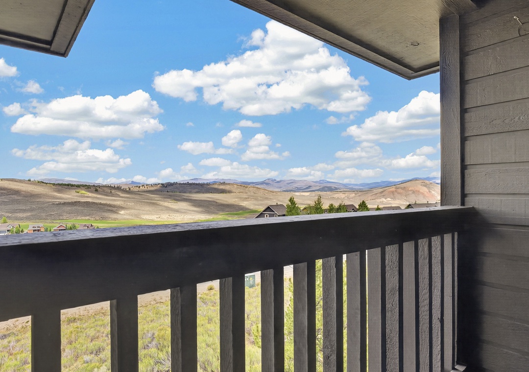 Sweeping mountain vistas stretch beyond your private balcony, where rolling hills and wide-open skies invite quiet mornings and peaceful evenings in your personal retreat.