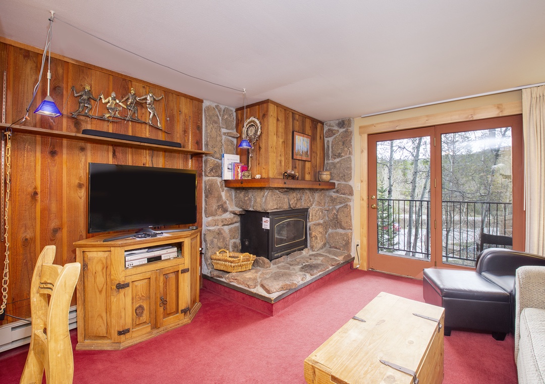 Cozy up by your stone fireplace while watching TV, then step onto your private balcony to enjoy peaceful tree views.