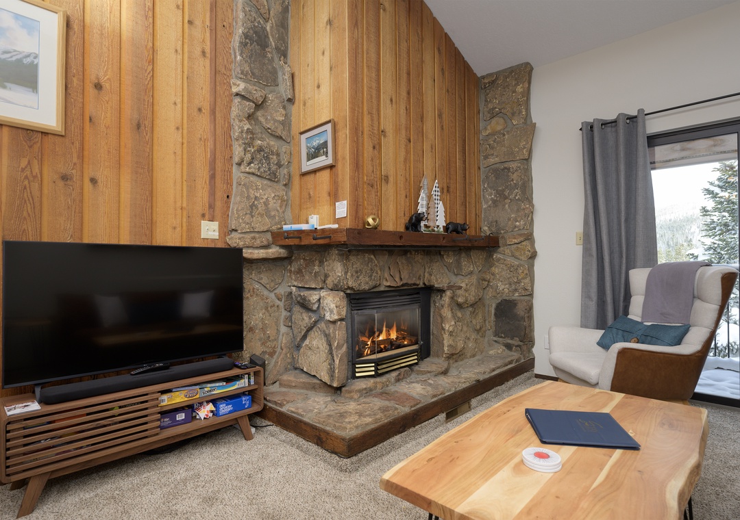 Cozy up by your crackling stone fireplace while snow falls outside your window, creating the perfect mountain retreat atmosphere.