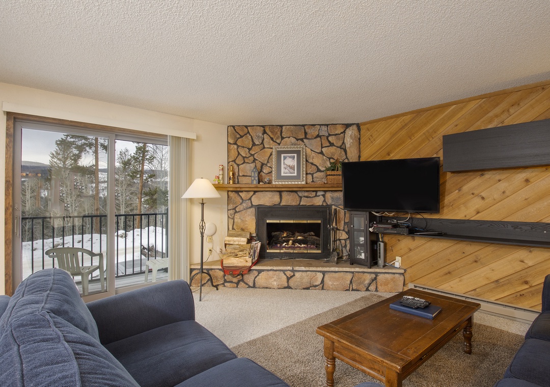 Cozy up by your stone fireplace in this inviting living space, complete with mountain views from your private balcony.