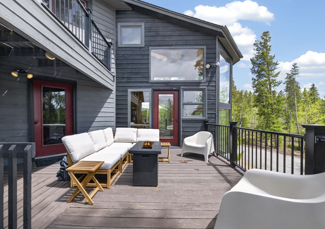 Relax on the spacious deck with plush lounge seating and soak in peaceful forest views from your private outdoor retreat.