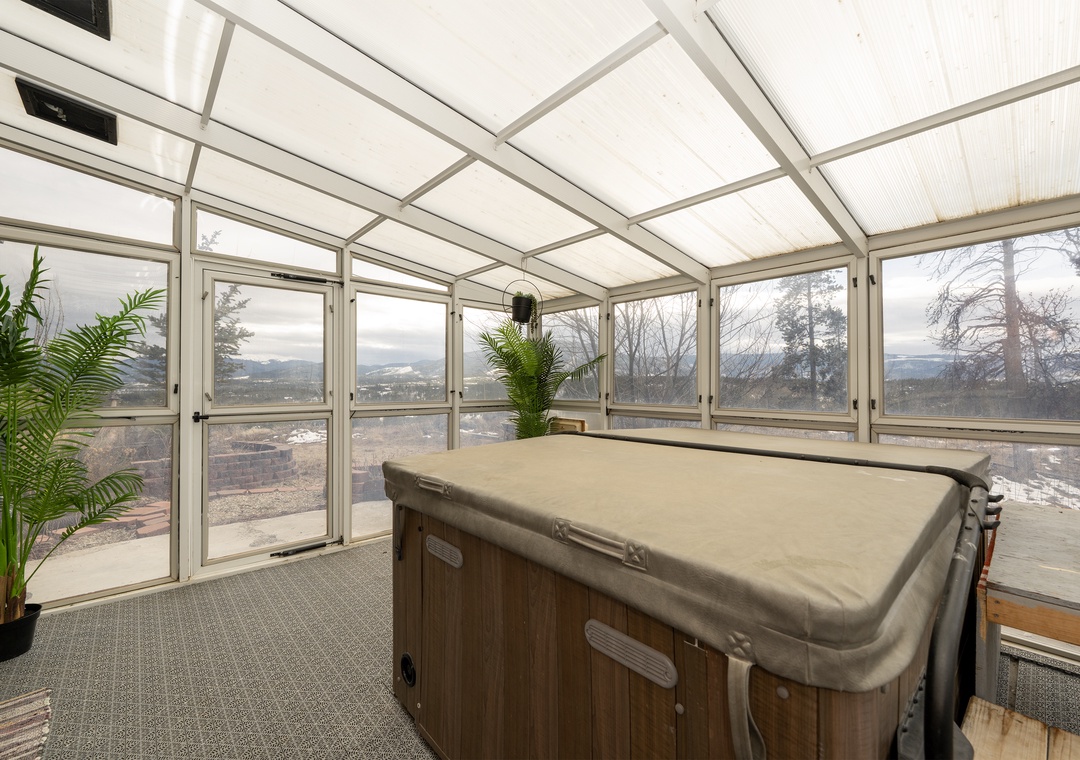Unwind in your private hot tub sanctuary, surrounded by floor-to-ceiling windows and breathtaking mountain views for the ultimate relaxation escape.
