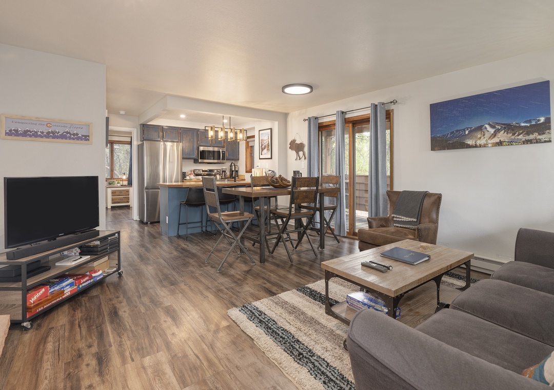 Relax in your open-plan living space with mountain views, modern kitchen, and comfortable seating for memorable moments.