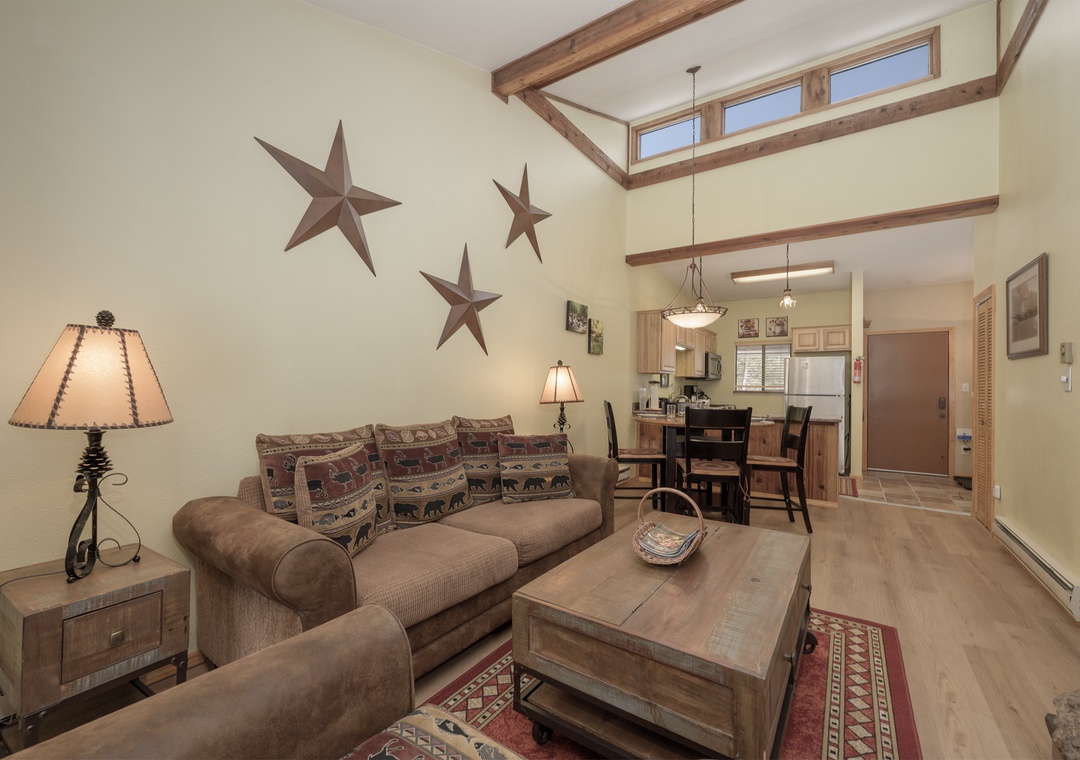 Relax in your rustic retreat with exposed beams, cozy seating, and western charm throughout this open-plan living space.