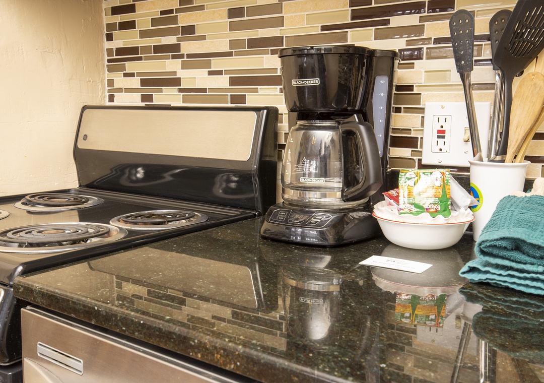 Your fully equipped kitchen features granite counters, electric stove, and coffee maker for cooking delicious meals during your stay.