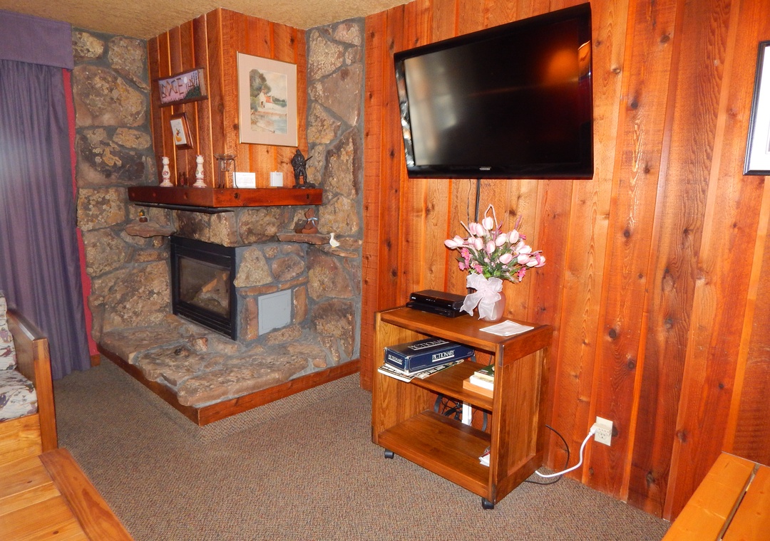 Unwind by your cozy stone fireplace while enjoying your favorite shows on the flat-screen TV in this warm, wood-paneled retreat.